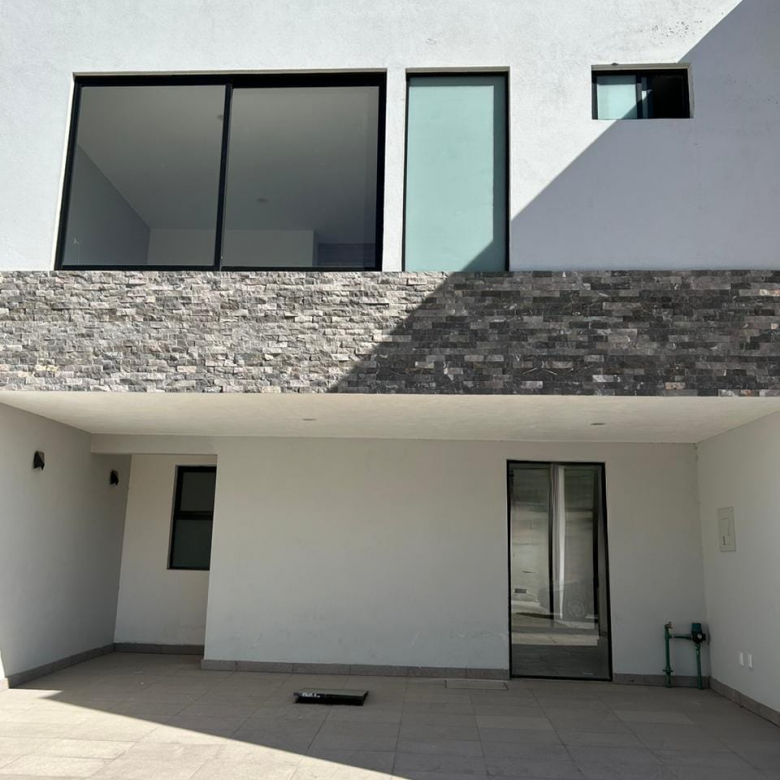 Fachada moderna de casa en venta en Fraccionamiento Cennet, San Luis Potosí con cochera para dos autos.