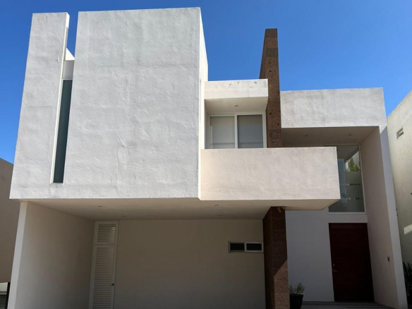 Fachada moderna de casa en venta en fraccionamiento Sierra Azul, San Luis Potosí, con cochera para 2 autos.