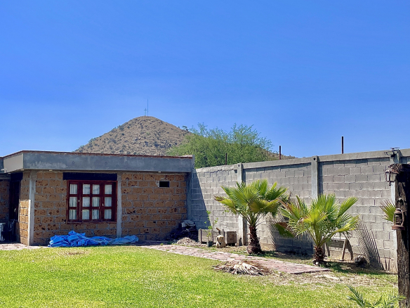 Quinta campestre en venta en Villa de Reyes, SLP - Vista del amplio jardín con alberca, palmeras y área de asador.